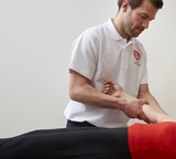 Photograph of Physiotherapist Chris Dudley treating a patient